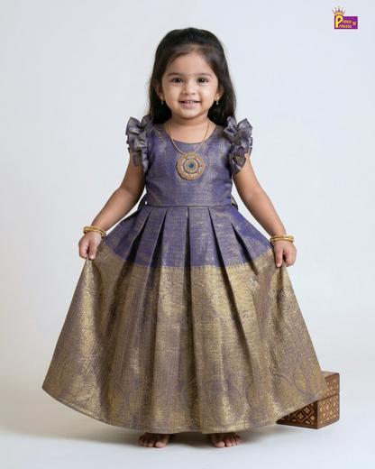 Young girl wearing a traditional outfit with a purple top and gold skirt on a white background
