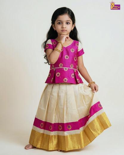 Young girl wearing a traditional outfit with a pink blouse and white and gold skirt on a white background.