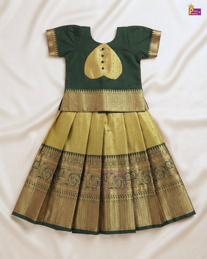 A traditional Indian girl's dress set featuring a dark green short-sleeve top with gold zari embroidery and a matching pleated gold skirt with dark green and gold borders, laid flat on a white fabric background.