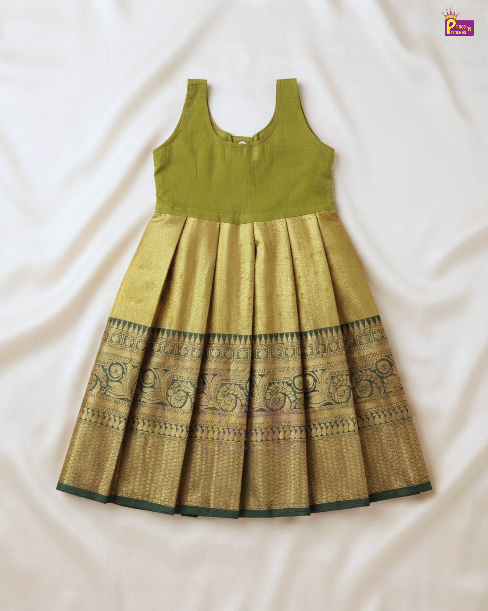 A sleeveless traditional Indian girl's dress laid flat on a white fabric background. The dress features an olive green sleeveless bodice and a pleated gold zari skirt with a dark green border pattern.