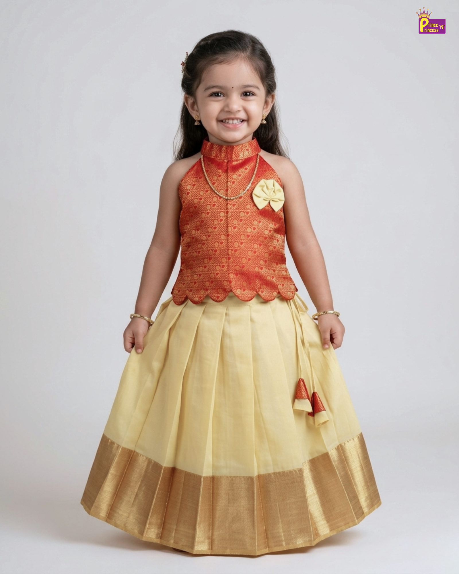Young girl wearing a traditional outfit with an orange top and yellow skirt on a white background