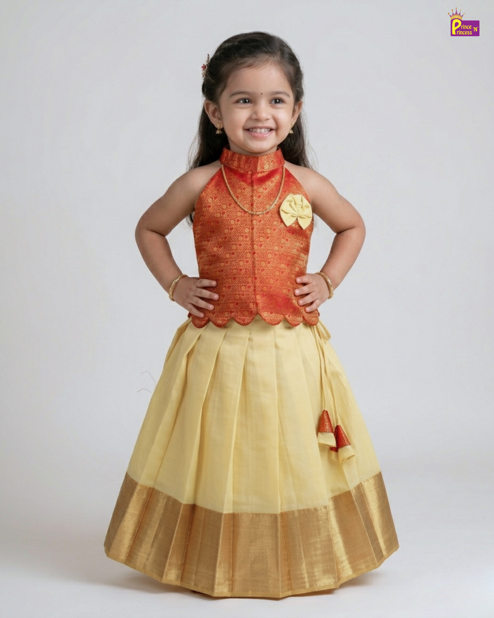 Young girl wearing a traditional outfit with an orange top and yellow skirt on a white background