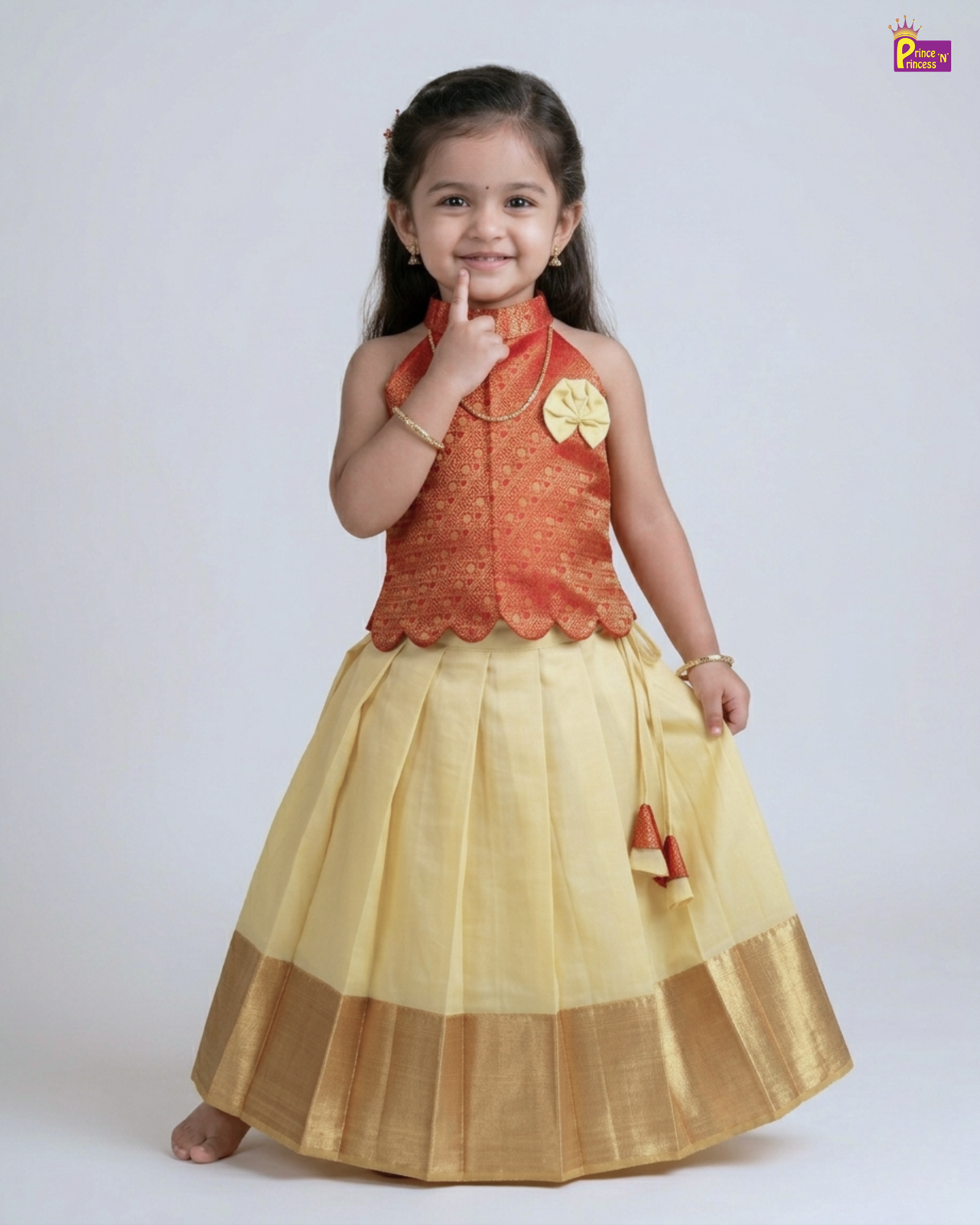 Young girl wearing a traditional outfit with a red top and yellow skirt on a white background