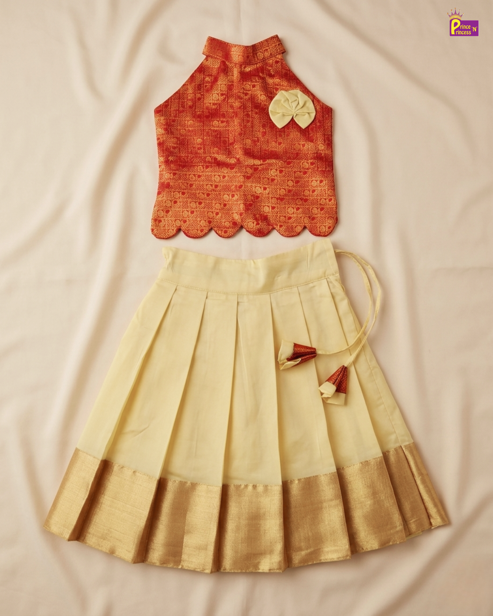 Orange top and beige skirt set on a beige fabric background