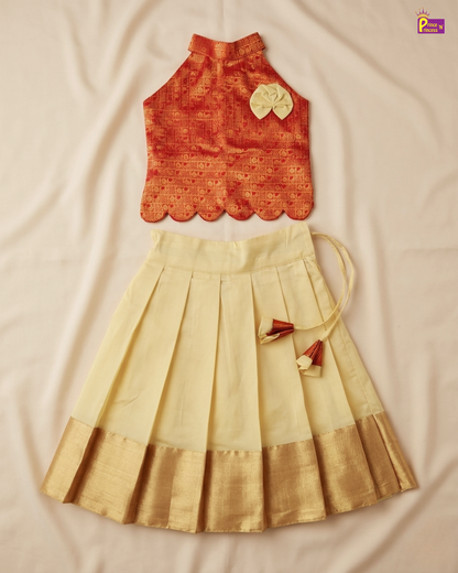 Orange top and beige skirt set on a beige fabric background