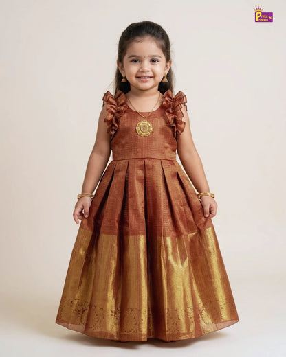 Young girl wearing a brown traditional dress with gold details on a white background