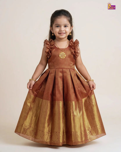 Young girl wearing a brown and gold dress on a white background