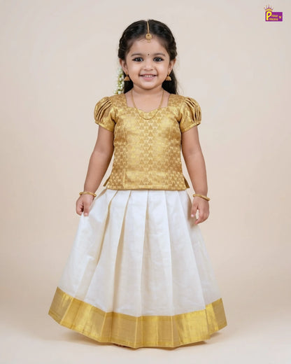 Young girl wearing a gold top and white skirt with gold border on a beige background