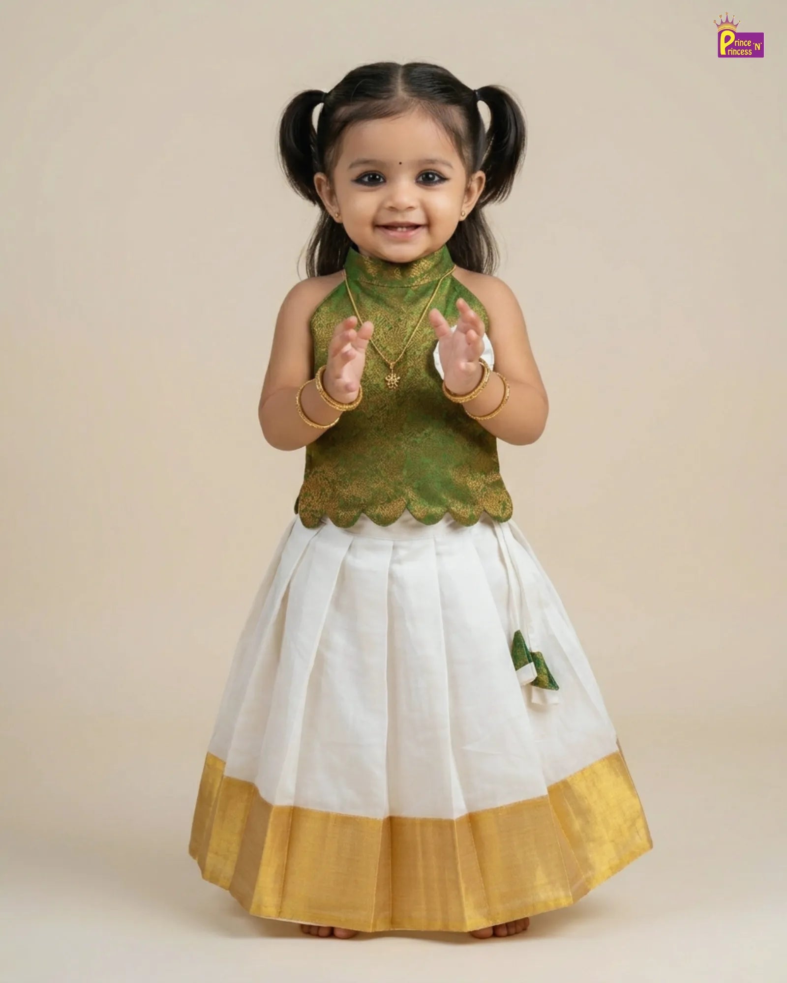 Child wearing a green and white traditional outfit with gold accents on a beige background