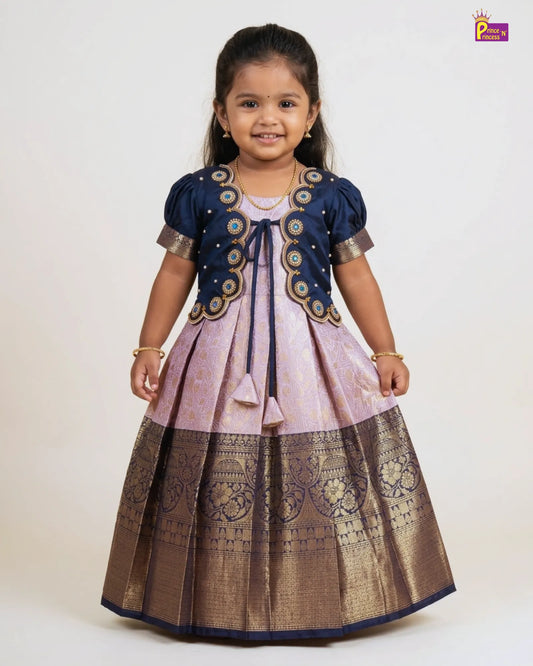 Young girl wearing a traditional outfit with a dark blue and brown dress on a white background