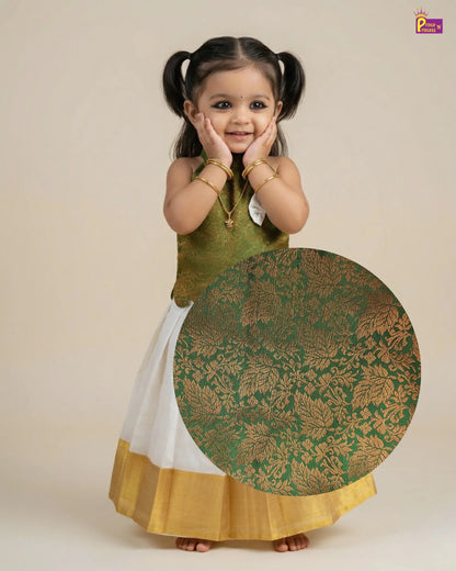 Young girl wearing a green and white traditional outfit with a large circular design.