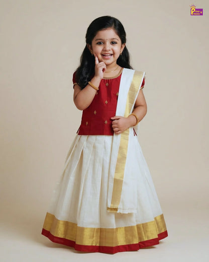Young girl wearing a traditional red and white outfit with gold accents on a beige background