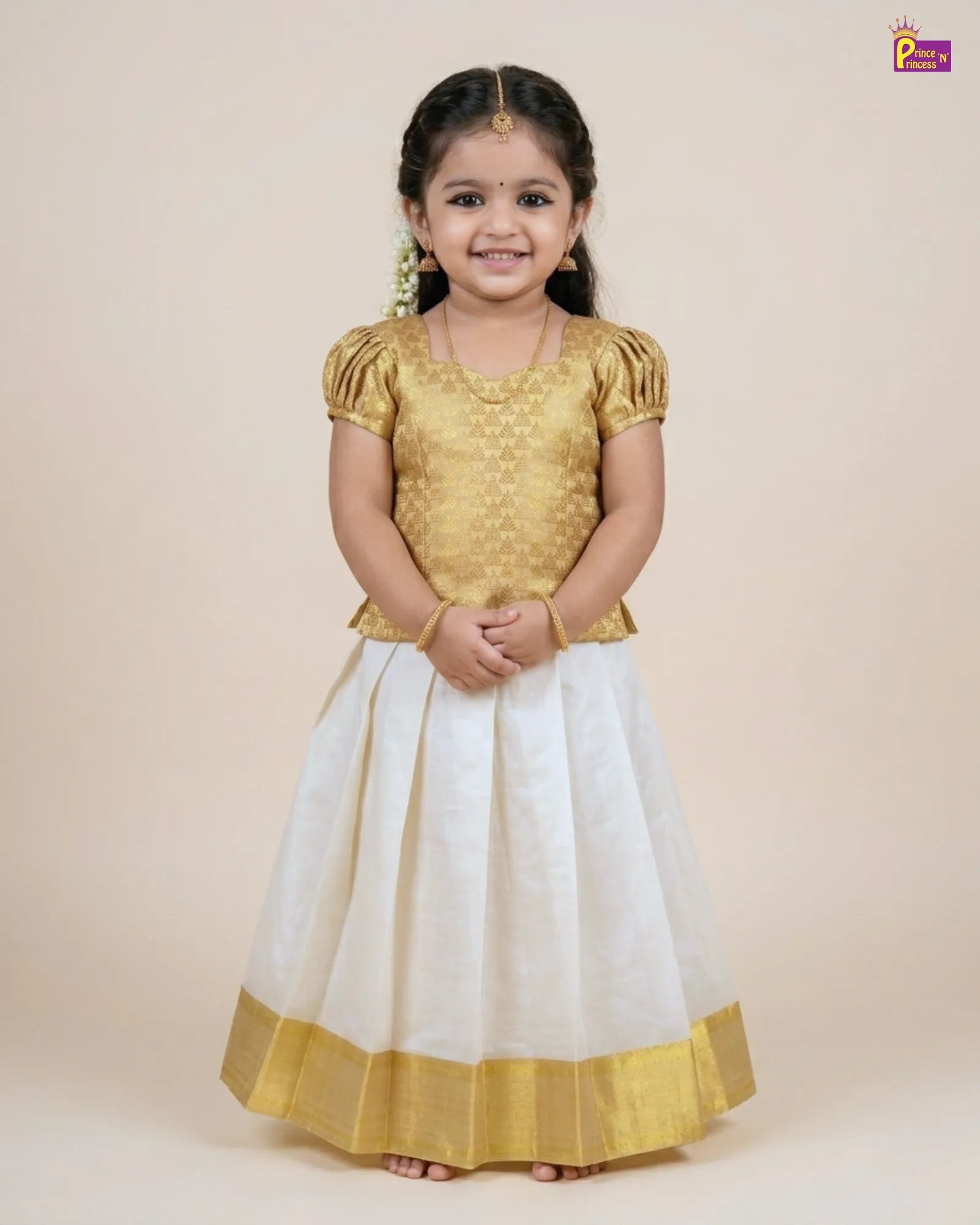 Young girl wearing a gold top and white skirt with gold border on a beige background
