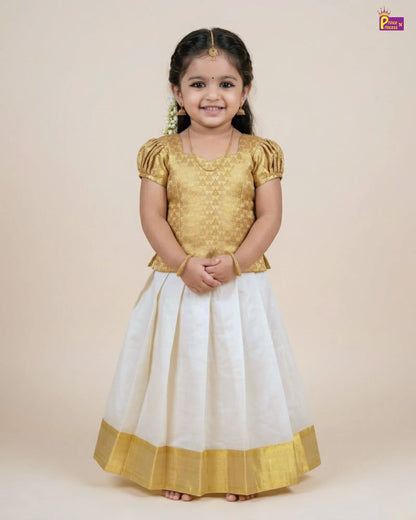 Young girl wearing a gold top and white skirt with gold border on a beige background