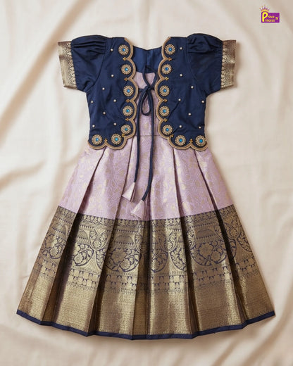 Traditional outfit with blue blouse and pink and gold skirt on a beige background