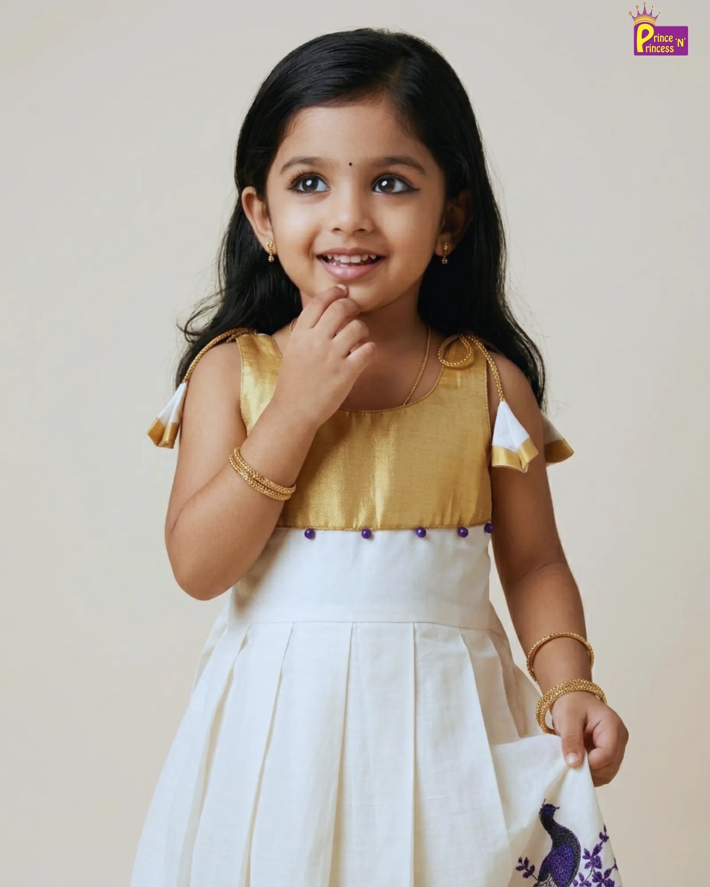 Young girl in a gold and white traditional outfit with a plain background