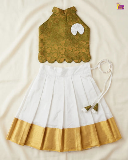 Traditional outfit with green top, white skirt, and gold border on a beige background