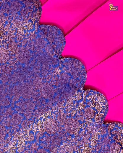 A close-up of a richly textured royal blue and gold brocade fabric with a scalloped edge, laid over a vibrant hot pink fabric background. A small 'Pune by Prashant' brand watermark is visible in the top right corner.