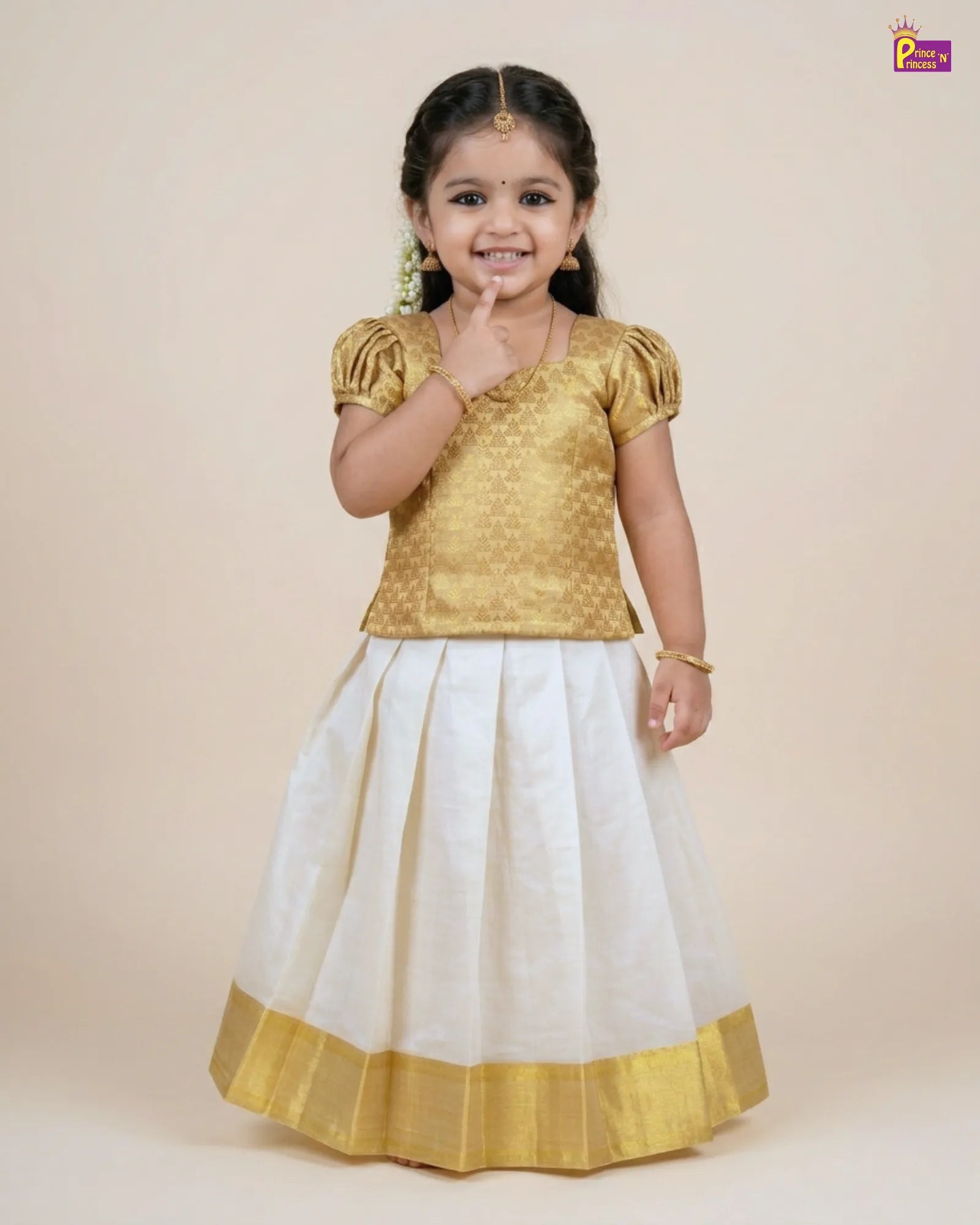 Young girl wearing a gold blouse and white skirt with yellow border on a beige background