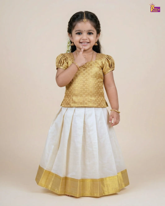 Young girl wearing a gold blouse and white skirt with yellow border on a beige background