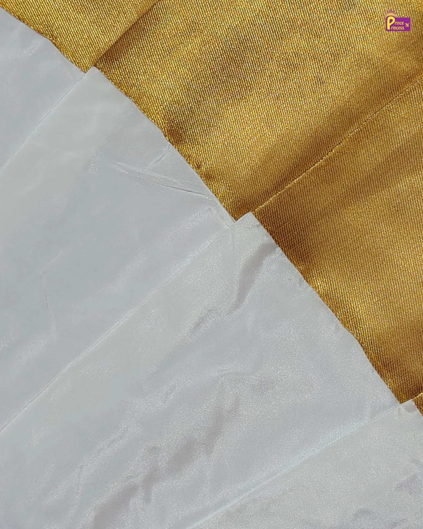 Close-up of white fabric with a gold border