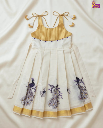 White dress with gold accents and peacock designs on a white background