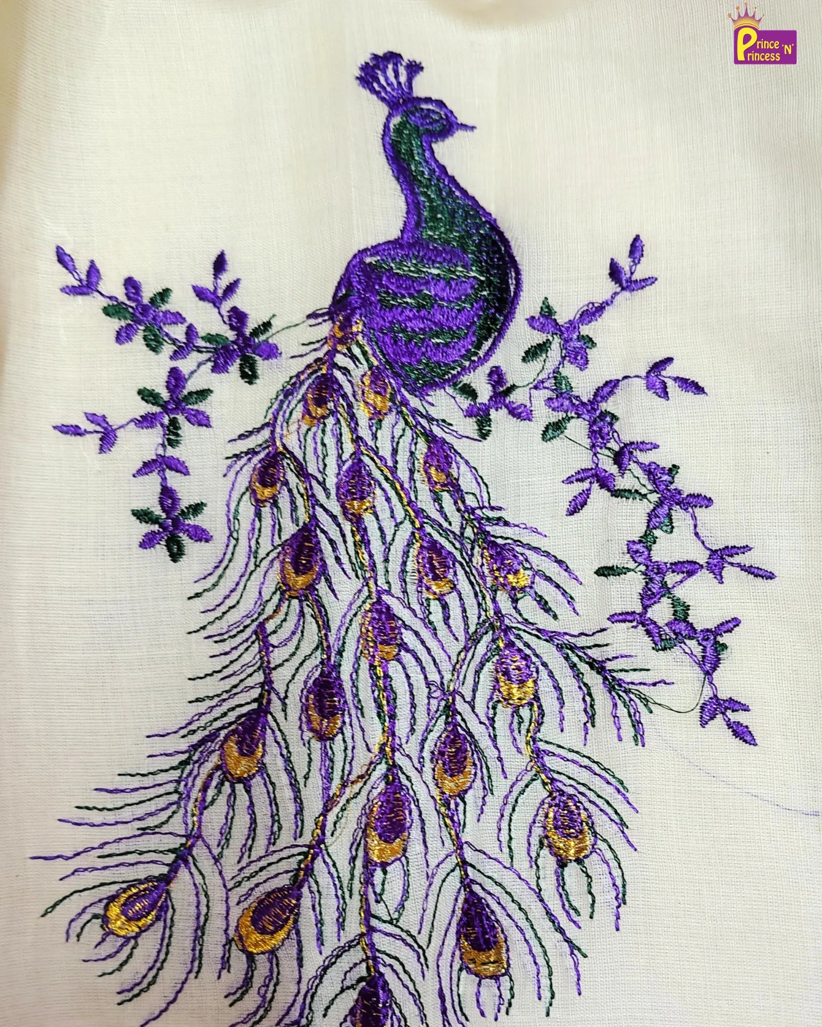 Embroidered peacock design on a white fabric with purple and green details.