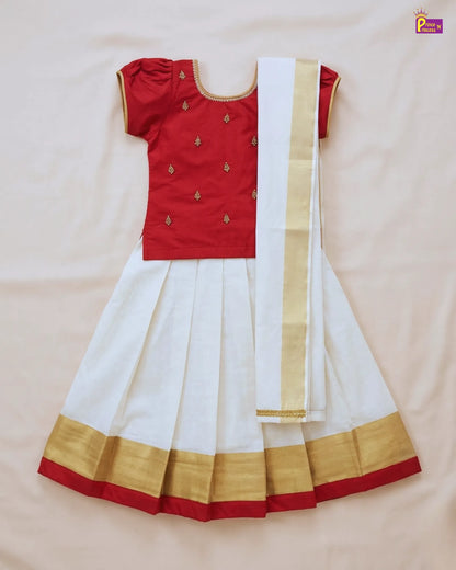 Red blouse with white saree and gold border on a beige background