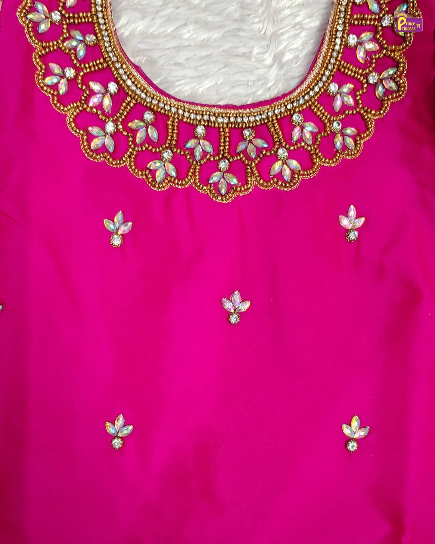 Pink blouse with intricate gold and white embroidery