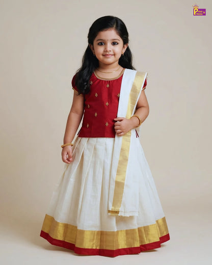 Young girl wearing a traditional outfit with a red blouse and white skirt on a plain background