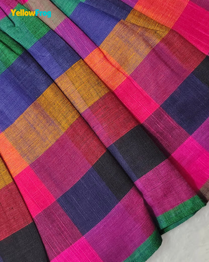 A close-up of a colorful plaid fabric with a textured weave, featuring blocks of magenta pink, purple, orange, green, black, and red. A yellow 'Yellow.