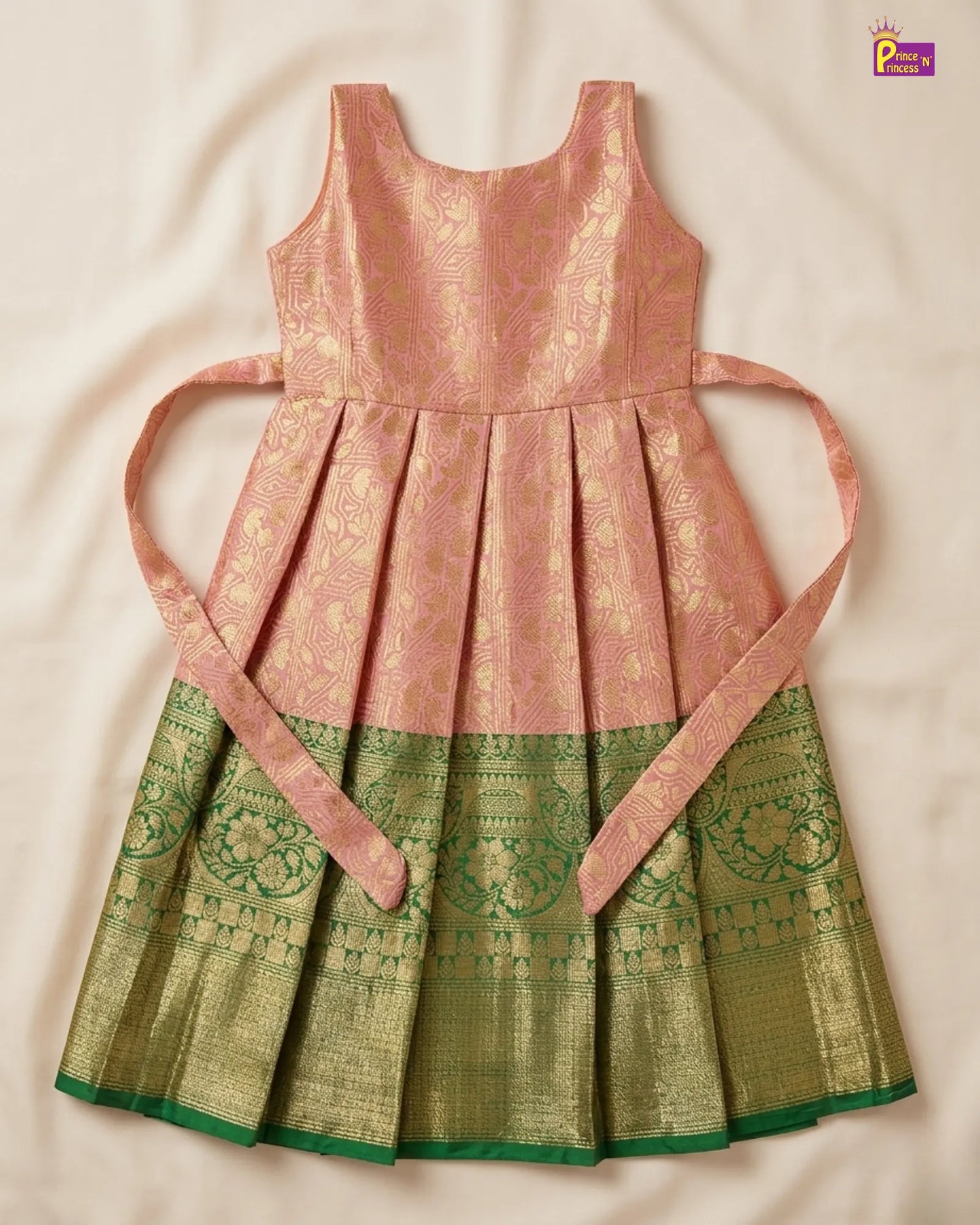 Traditional dress with pink top and green bottom on a beige background