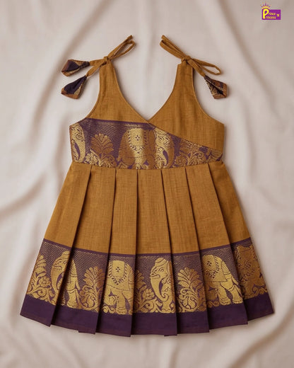 Mustard yellow dress with purple and gold elephant patterns on a beige background