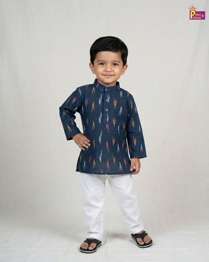 Child wearing a navy blue kurta with colorful patterns and white pants on a light gray background.