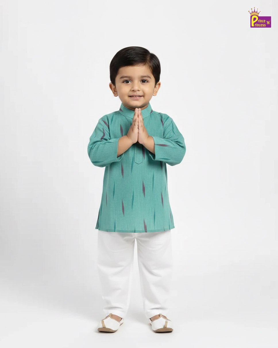 Child wearing a green kurta with white pants on a white background