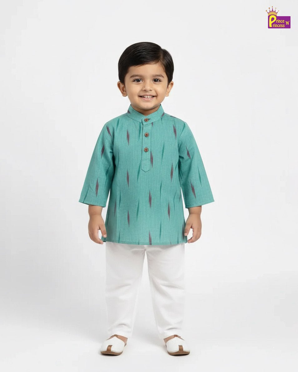 Child wearing a green kurta with white pants on a white background
