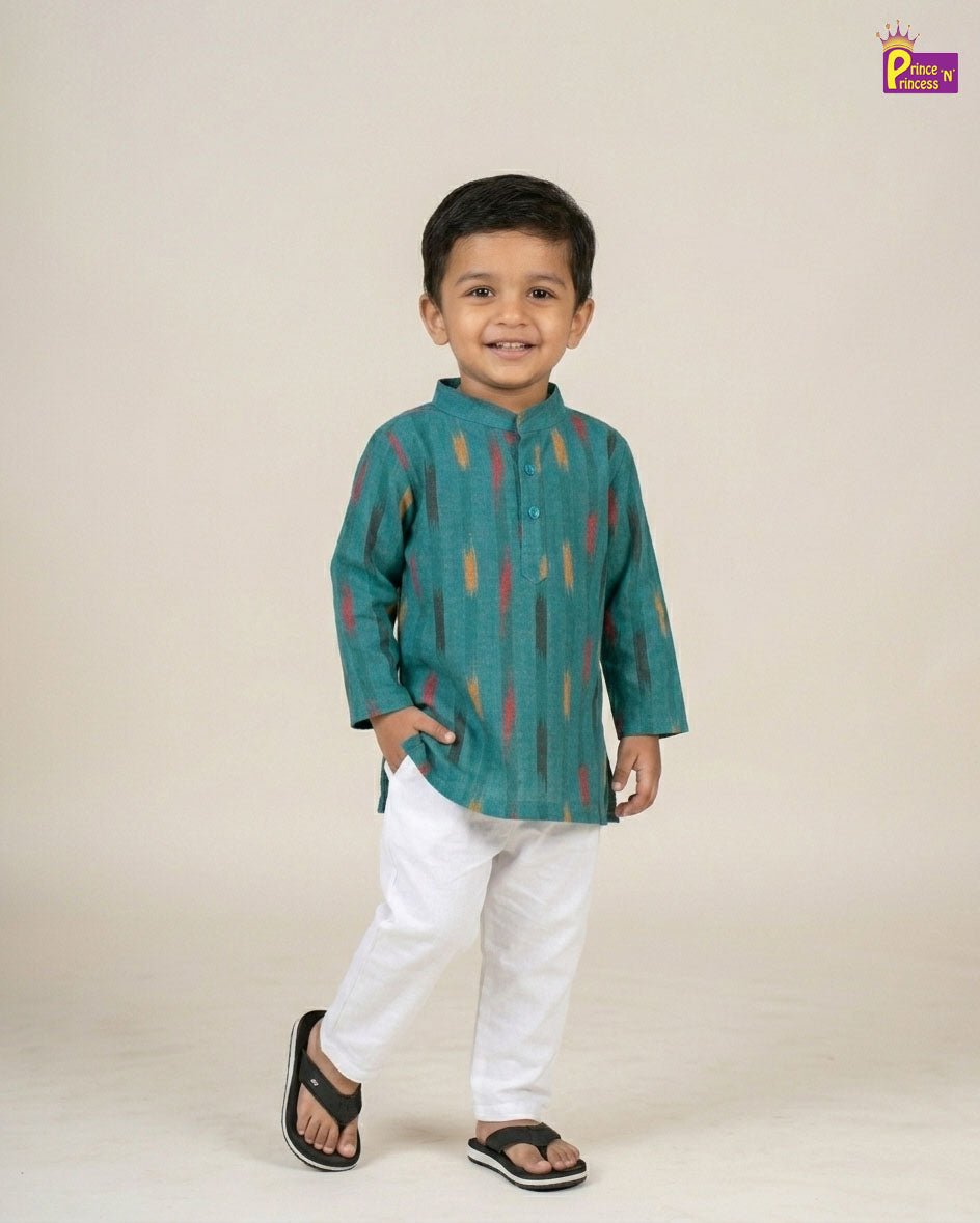 Child wearing a teal kurta with colorful patterns on a beige background