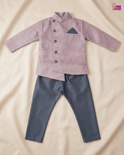 Children's outfit with a pink shirt and gray pants on a beige fabric background