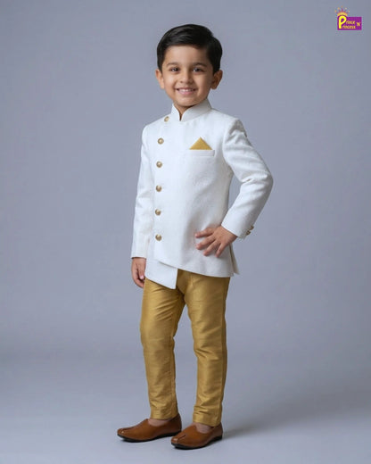 Young boy wearing a white traditional outfit with gold accents on a gray background