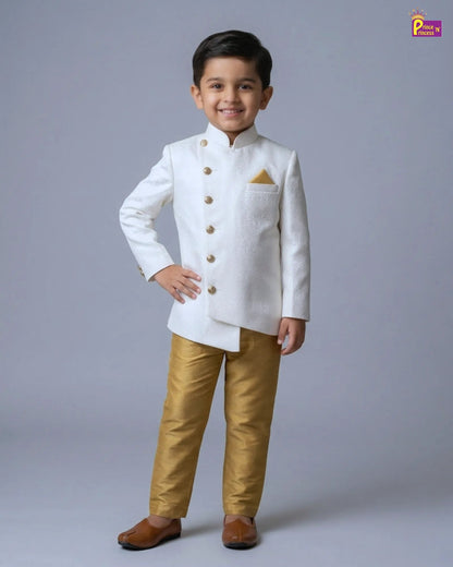 Child wearing a white traditional outfit with gold pants on a gray background