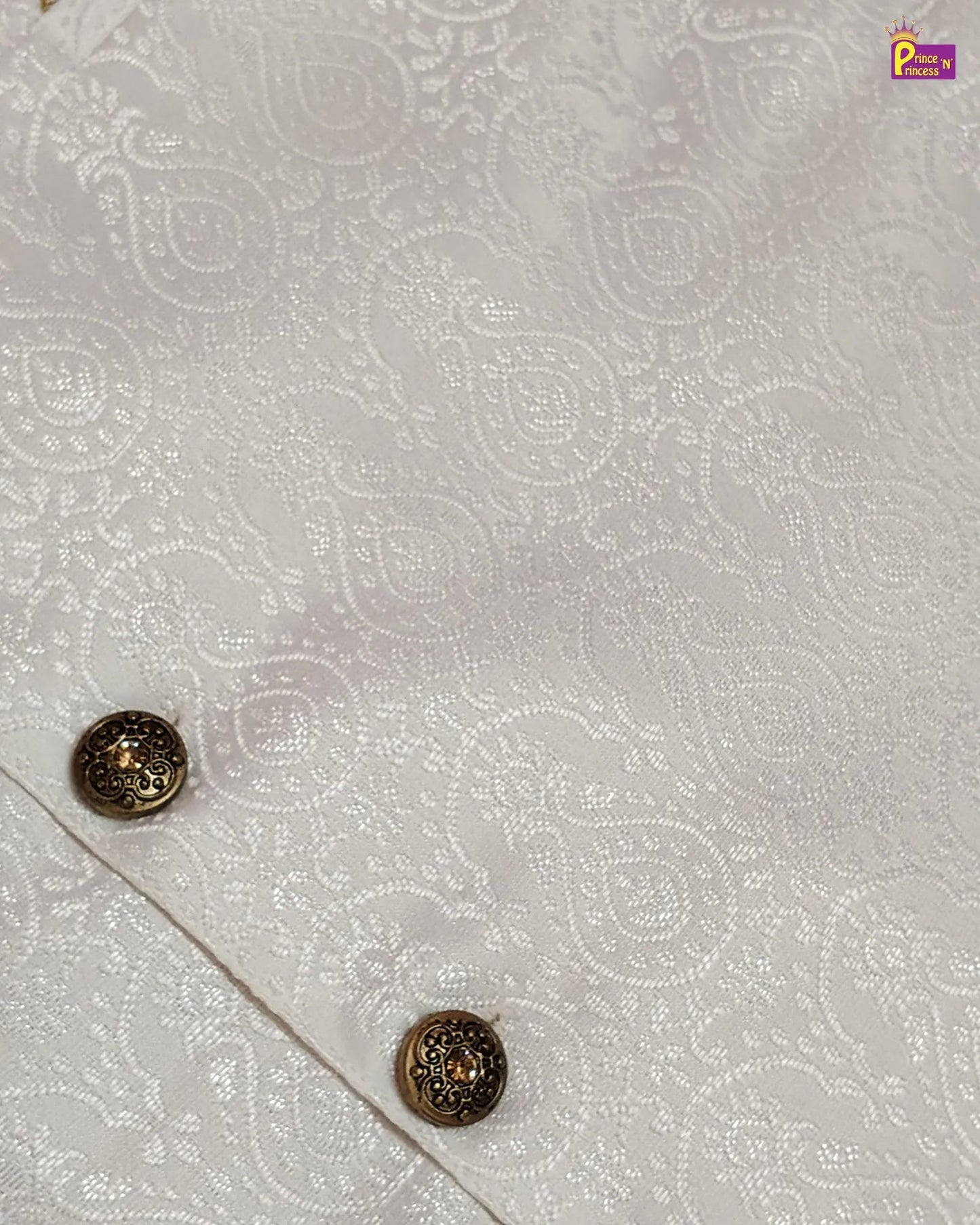 Decorative buttons on a white fabric with intricate patterns
