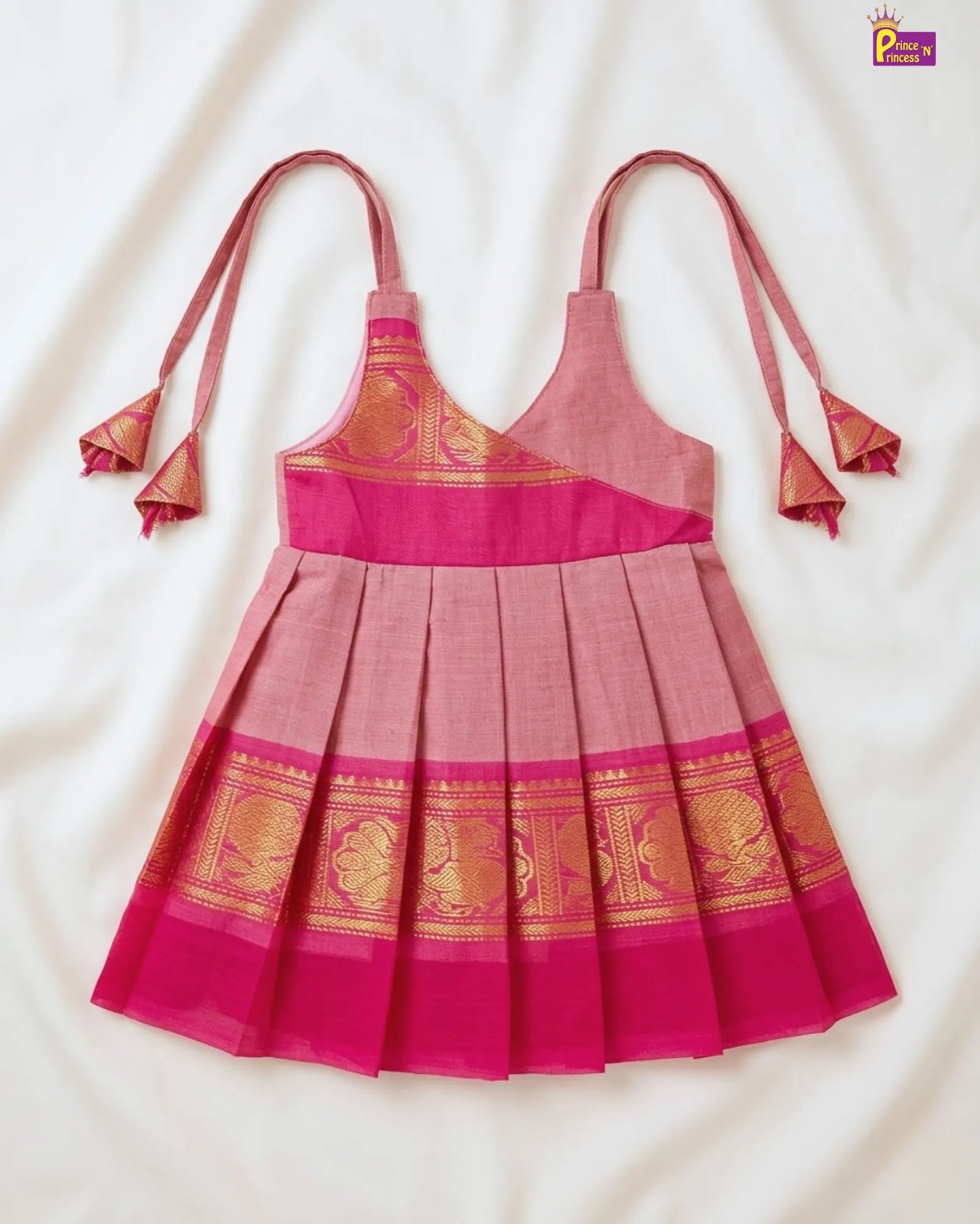 Pink dress with gold patterns on a white background