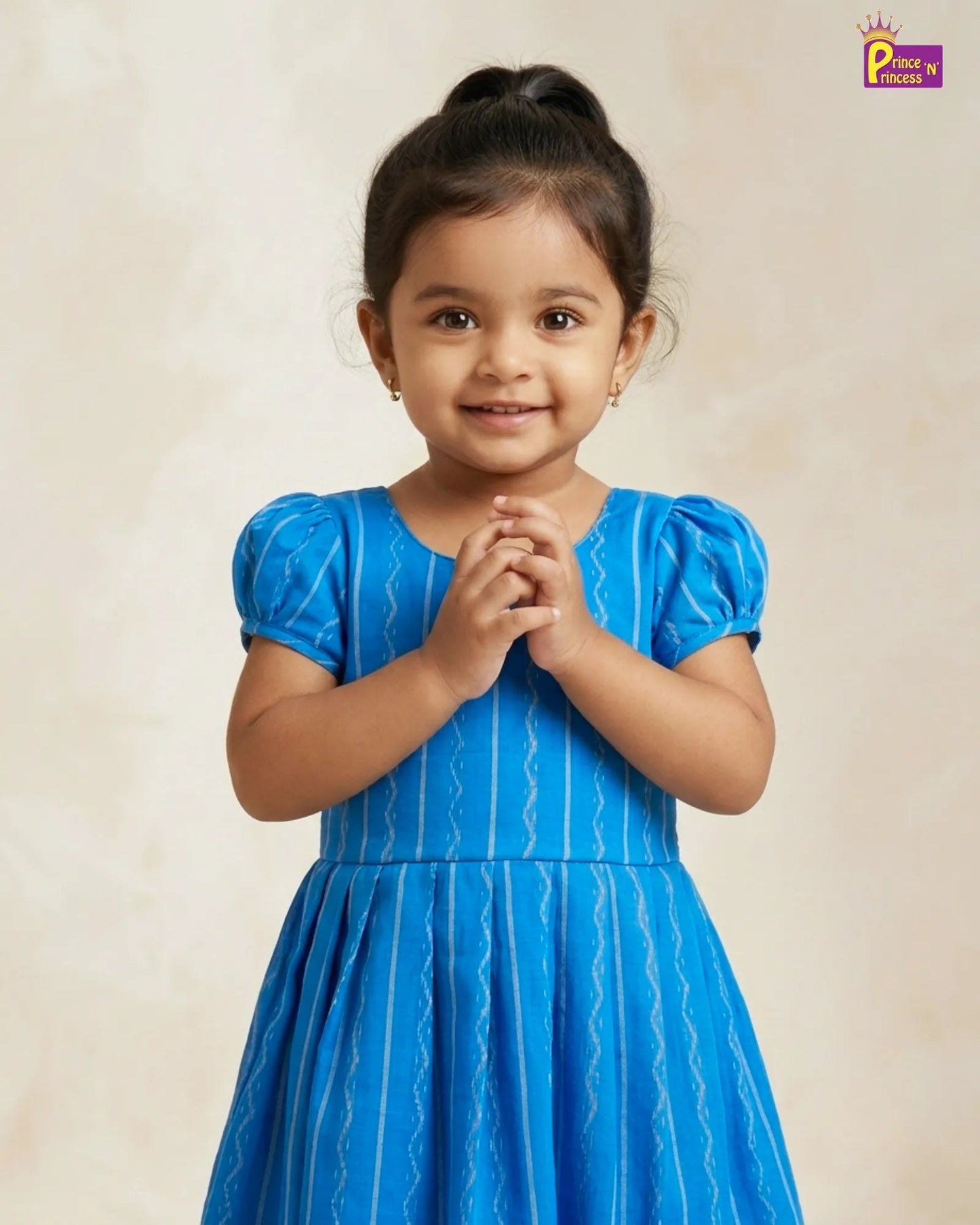 Young girl in a blue dress with a plain background