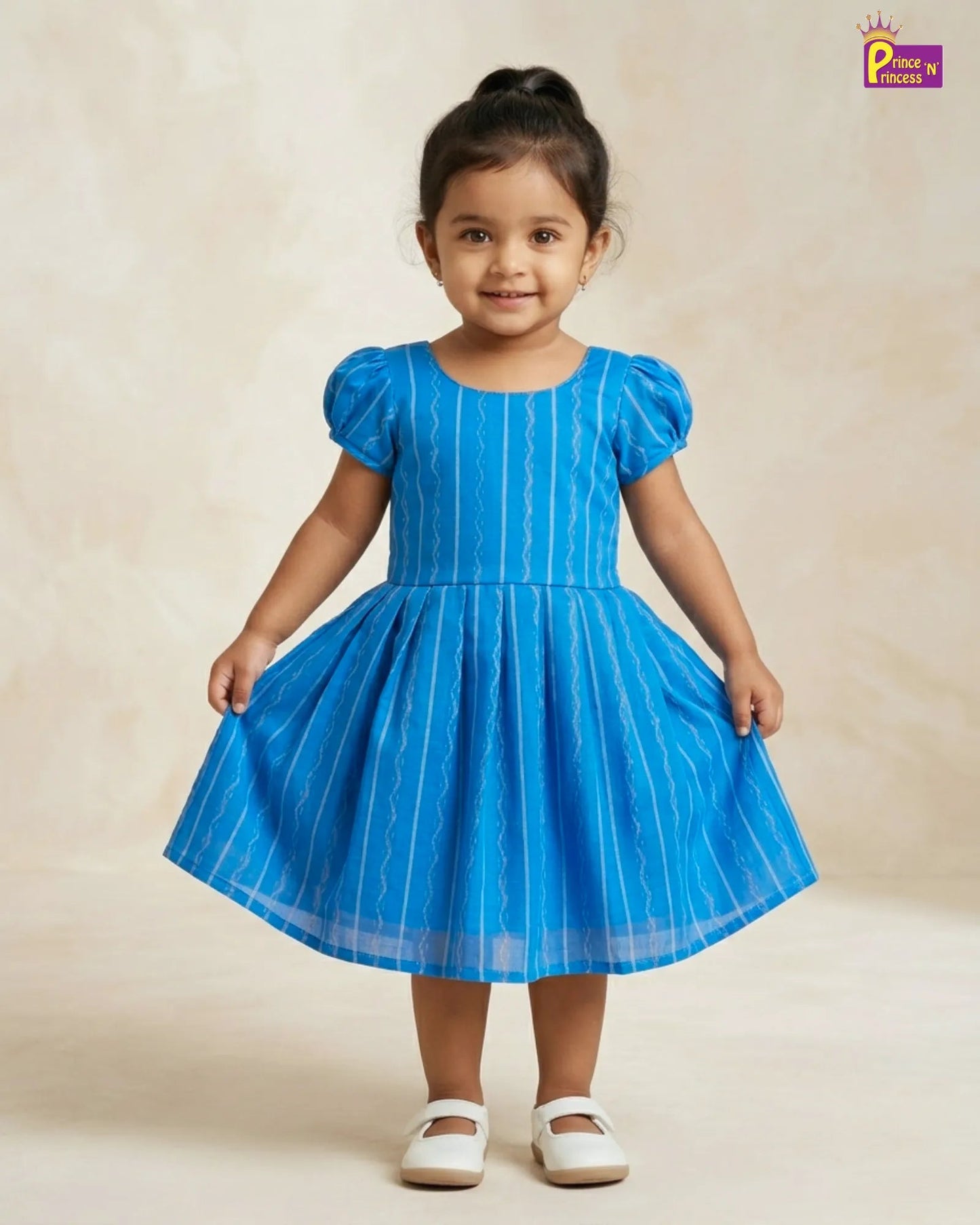 Child wearing a blue dress with white stripes on a beige background