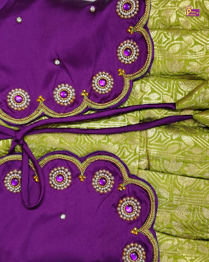Purple and green traditional outfit with intricate embroidery