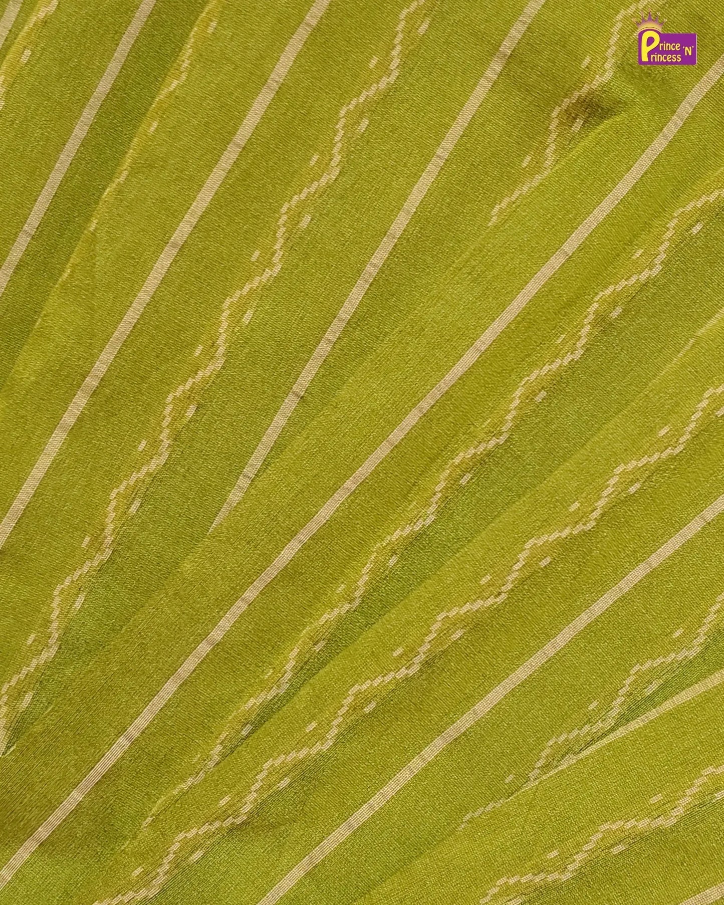 A close-up of a green fabric with diagonal cream-colored stripes and woven zigzag patterns, showing the material texture.