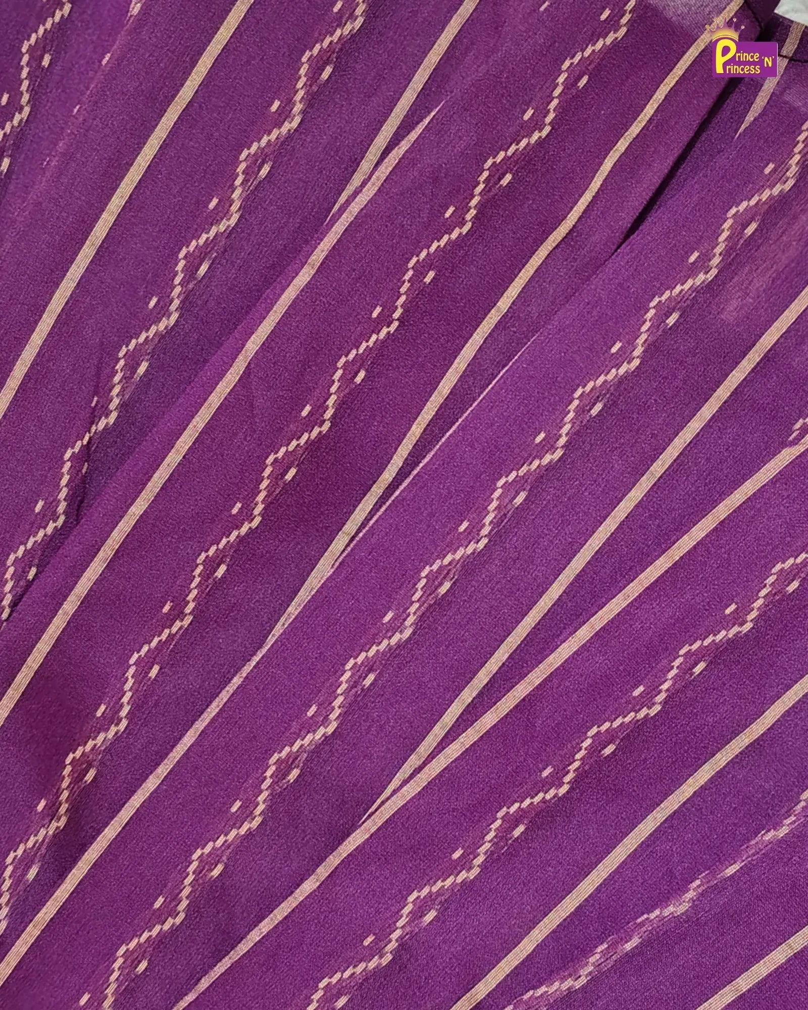 A close-up of a purple fabric with diagonal gold stripes and woven geometric patterns, showing the material texture and weave.