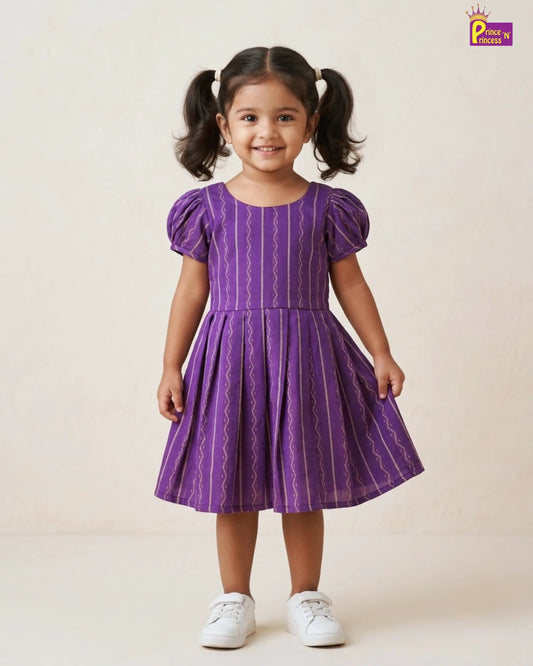 Young girl wearing a purple dress with white sneakers on a beige background
