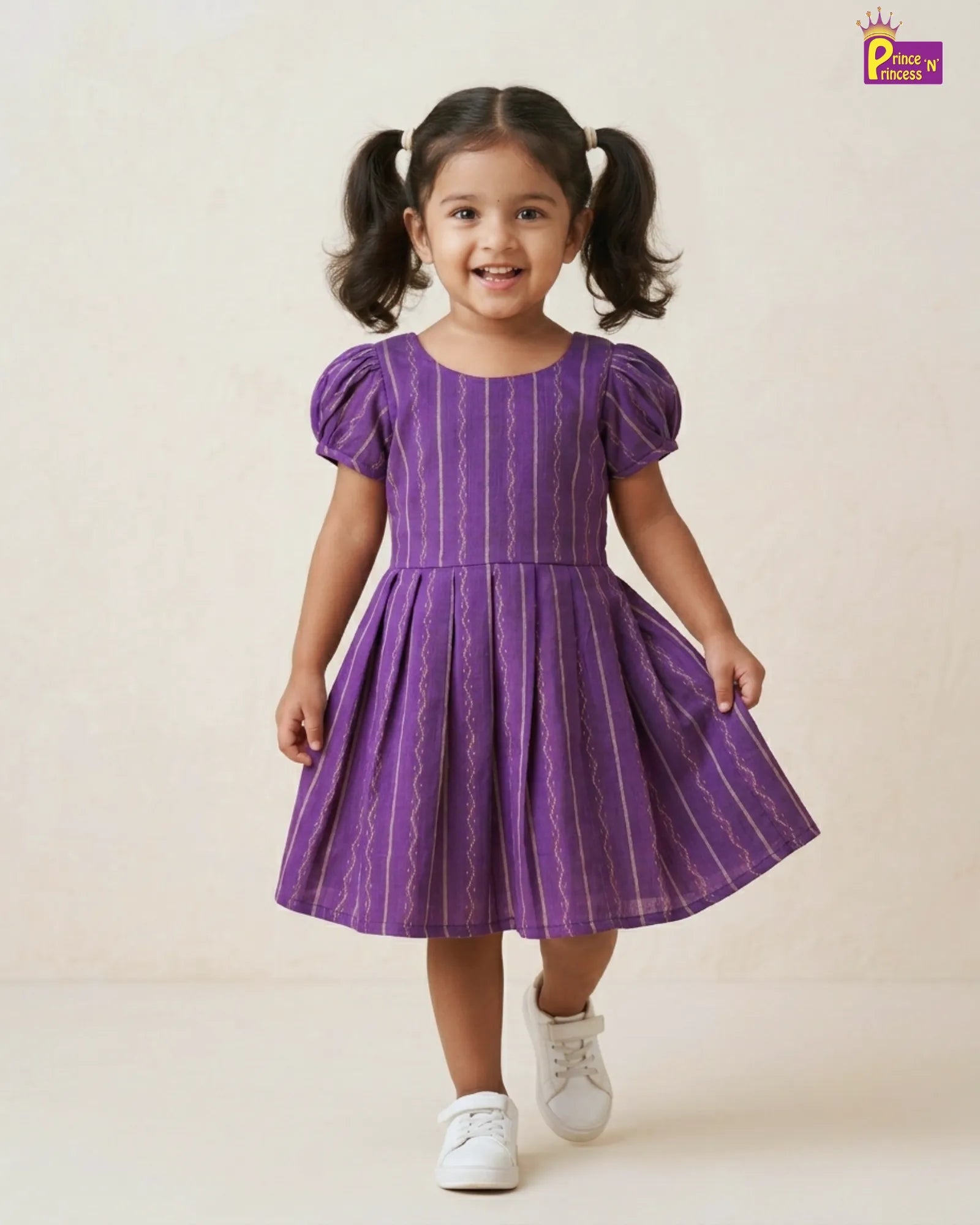 Young girl wearing a purple dress with puffed sleeves on a beige background