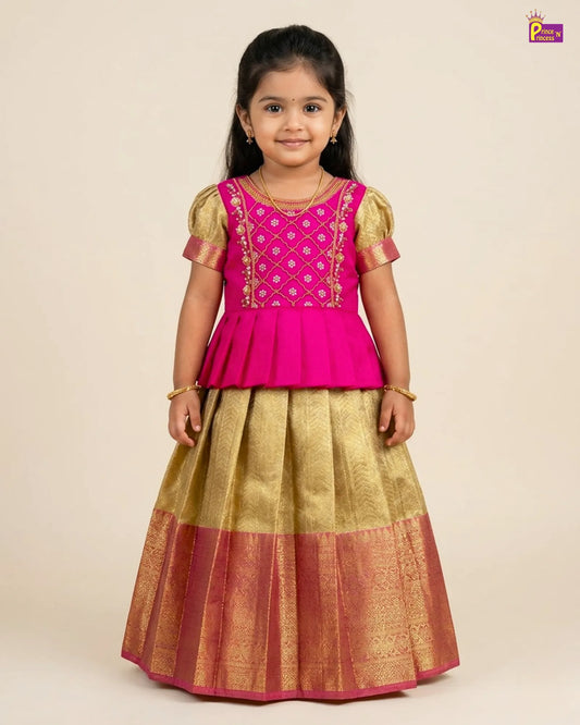 Young girl wearing a pink and gold traditional outfit on a beige background